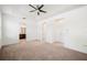 Spacious main bedroom with tray ceiling, fan, plush carpet, and an ensuite bathroom at 2846 Sera Bella Way, Kissimmee, FL 34744