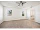 Main bedroom with carpet floors, tray ceiling, fan, and two windows at 2846 Sera Bella Way, Kissimmee, FL 34744