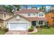 Charming two-story home with a red tile roof, two car garage and well-manicured landscaping at 320 Mockingbird Rd, Davenport, FL 33896