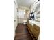 Bathroom featuring a farmhouse sink, modern fixtures, ladder shelving and a round mirror at 1464 Mount Pleasant Rd, Groveland, FL 34736