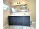 Bathroom with a double vanity sink, a large mirror, and a herringbone patterned floor at 1464 Mount Pleasant Rd, Groveland, FL 34736