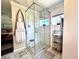 Modern bathroom featuring a glass-enclosed shower with stylish tile and herringbone floor pattern at 1464 Mount Pleasant Rd, Groveland, FL 34736