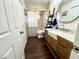 Bathroom featuring a farmhouse sink, modern fixtures, ladder shelving and a round mirror at 1464 Mount Pleasant Rd, Groveland, FL 34736