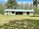 Charming single story home with a metal roof and a large front yard perfect for outdoor activities at 1464 Mount Pleasant Rd, Groveland, FL 34736