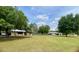Picturesque property featuring multiple homes and a large, well-maintained lawn with mature trees and lush greenery at 1464 Mount Pleasant Rd, Groveland, FL 34736