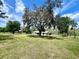 Expansive property with a well-maintained lawn, mature trees and a single story home providing ample space at 1464 Mount Pleasant Rd, Groveland, FL 34736