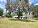 Expansive property with a well-maintained lawn, mature trees and a single story home providing ample space at 1464 Mount Pleasant Rd, Groveland, FL 34736