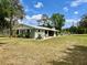 Charming single story home featuring a metal roof, nice landscaping, and a spacious yard at 1464 Mount Pleasant Rd, Groveland, FL 34736