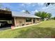Exterior of home with carport, updated siding, and metal roof on a lush, green lawn at 1464 Mount Pleasant Rd, Groveland, FL 34736
