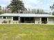 Charming single-story home with a metal roof, a well-manicured lawn and inviting porch seating at 1464 Mount Pleasant Rd, Groveland, FL 34736