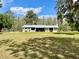 Welcoming front yard featuring lush green grass and a charming home, creating a picturesque curb appeal at 1464 Mount Pleasant Rd, Groveland, FL 34736