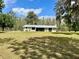 Well-maintained home featuring a lush front lawn and mature trees, offering a peaceful and inviting setting at 1464 Mount Pleasant Rd, Groveland, FL 34736