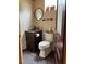 Convenient half bathroom with wood vanity, round mirror, and updated fixtures at 1464 Mount Pleasant Rd, Groveland, FL 34736