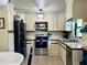 Well-lit kitchen featuring stainless steel appliances, tile floors, and modern cabinetry at 1464 Mount Pleasant Rd, Groveland, FL 34736