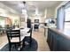 Eat-in kitchen with stainless steel appliances, white cabinets, and a dining table at 1464 Mount Pleasant Rd, Groveland, FL 34736