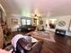 Inviting living room featuring wood floors, a brick fireplace, and an open view into the dining room at 1464 Mount Pleasant Rd, Groveland, FL 34736