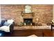 Living room features an attractive fireplace surrounded by brick and hardwood floors at 1464 Mount Pleasant Rd, Groveland, FL 34736