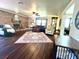 Cozy living room with a brick fireplace, ceiling fan, and hardwood floors at 1464 Mount Pleasant Rd, Groveland, FL 34736