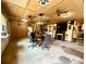 Large office area featuring multiple ceiling fans, a fireplace, and a wooden table, creating an inviting workspace at 1464 Mount Pleasant Rd, Groveland, FL 34736
