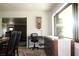 Bright office area featuring a desk, large window, and decorative vintage-style table lamp, creating an inviting workspace at 1464 Mount Pleasant Rd, Groveland, FL 34736