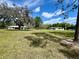Expansive grassy property with multiple single-story homes and mature trees on a sunny day at 1464 Mount Pleasant Rd, Groveland, FL 34736