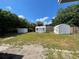 Spacious backyard featuring three outdoor sheds providing ample storage and utility space at 213 5Th Jpv St, Winter Haven, FL 33880