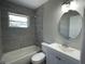 Modern bathroom with tiled shower over tub, new vanity, and a neutral color scheme creating a spa-like retreat at 213 5Th Jpv St, Winter Haven, FL 33880