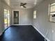 Bedroom with ceiling fan, sliding glass doors to the backyard and an attached bathroom at 213 5Th Jpv St, Winter Haven, FL 33880