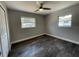 Cozy bedroom with neutral paint and ceiling fan providing a relaxing atmosphere and natural light at 213 5Th Jpv St, Winter Haven, FL 33880