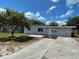 Charming single-story home with a well-maintained lawn, mature tree, and a long driveway at 213 5Th Jpv St, Winter Haven, FL 33880