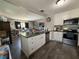 Open concept kitchen with granite counters, stainless appliances, and white cabinetry at 213 5Th Jpv St, Winter Haven, FL 33880