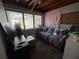 Cozy living room with a comfortable couch, large window, and dark laminate flooring at 213 5Th Jpv St, Winter Haven, FL 33880