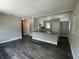 Open-concept living room and kitchen area featuring modern finishes, granite countertops, and stylish gray color palette at 213 5Th Jpv St, Winter Haven, FL 33880