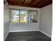 Bright sunroom with wood-planked ceiling and large windows providing natural light and views of the surrounding landscape at 213 5Th Jpv St, Winter Haven, FL 33880