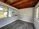 Bright sunroom with wood-planked ceiling and large windows providing natural light and views of the surrounding landscape at 213 5Th Jpv St, Winter Haven, FL 33880