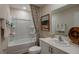 Modern bathroom featuring a tub, a shower, and a sleek vanity with decorative accents at 3856 King Hill Dr, Haines City, FL 33844