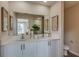 Bright bathroom featuring a dual sink vanity with white cabinets and stylish decor at 3856 King Hill Dr, Haines City, FL 33844