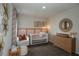 Charming Bedroom with a crib, accent chair, dresser, and decorative wall art at 3856 King Hill Dr, Haines City, FL 33844