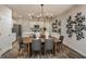 Dining area with stylish light fixture, seating for six, and modern decor at 3856 King Hill Dr, Haines City, FL 33844