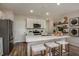 Modern kitchen featuring stainless steel appliances, a center island, and breakfast bar at 3856 King Hill Dr, Haines City, FL 33844