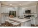 Bright kitchen featuring white cabinets, stainless steel appliances, and a center island at 3856 King Hill Dr, Haines City, FL 33844