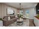 Comfortable living room with stylish decor, plush seating, and a modern chandelier at 3856 King Hill Dr, Haines City, FL 33844