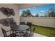 Private patio with a table, four chairs, and decorative metal art at 3856 King Hill Dr, Haines City, FL 33844