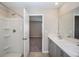 Bright bathroom featuring double sinks with a shower-tub combo with a view into the bedroom at 4043 Gardenia Ave, Lake Hamilton, FL 33851