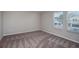 Comfortable bedroom with natural light showcasing carpet and neutral wall color scheme at 4043 Gardenia Ave, Lake Hamilton, FL 33851