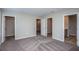 Spacious bedroom featuring neutral walls, plush carpeting, and multiple doorways leading to closets and the bathroom at 4043 Gardenia Ave, Lake Hamilton, FL 33851