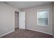 Comfortable bedroom featuring plush carpeting, a window with blinds, and a walk-in closet at 4043 Gardenia Ave, Lake Hamilton, FL 33851