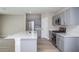 Modern kitchen features stainless steel appliances, light grey cabinets, and a spacious kitchen island at 4043 Gardenia Ave, Lake Hamilton, FL 33851