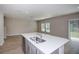 Bright kitchen island, complete with stainless steel sink and faucet, is perfect for meal prep at 4043 Gardenia Ave, Lake Hamilton, FL 33851