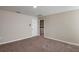 Bedroom with plush carpeting and a view of a laundry room at 4075 Gardenia Ave, Lake Hamilton, FL 33851